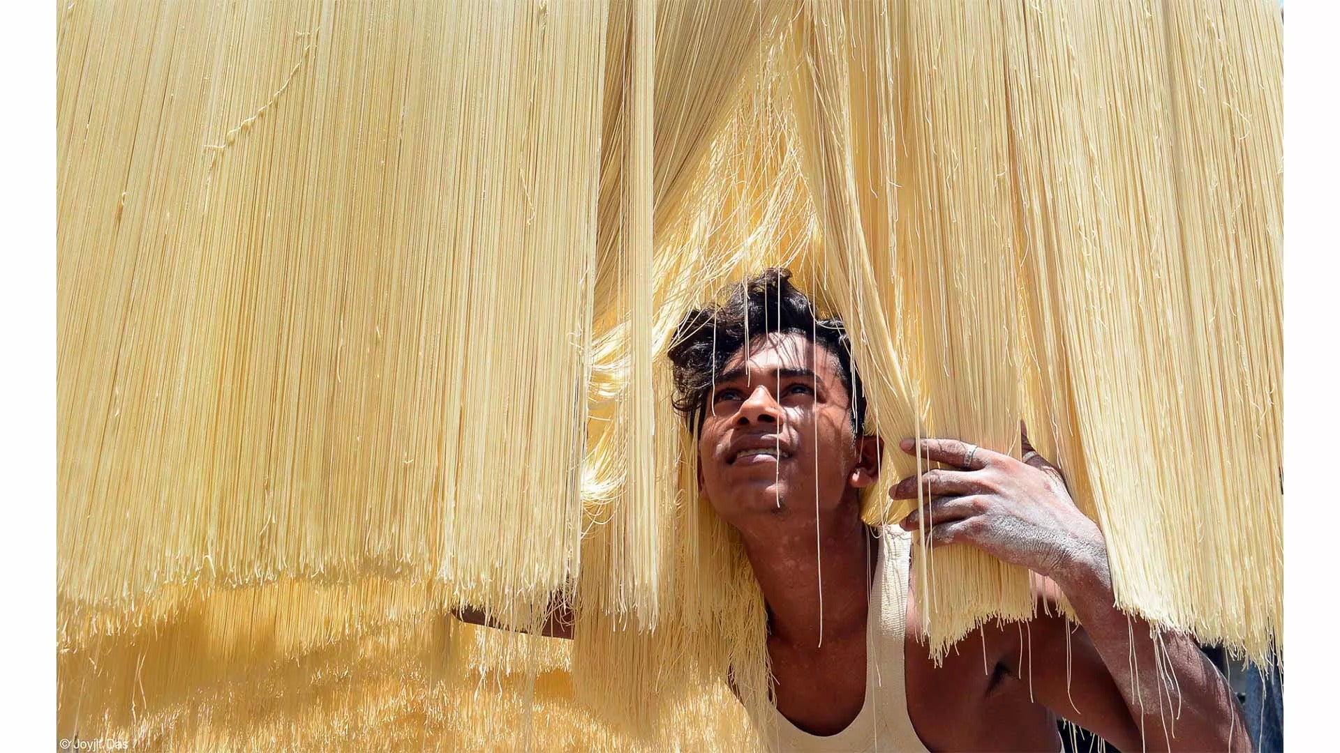 boy is working on drying raw semai