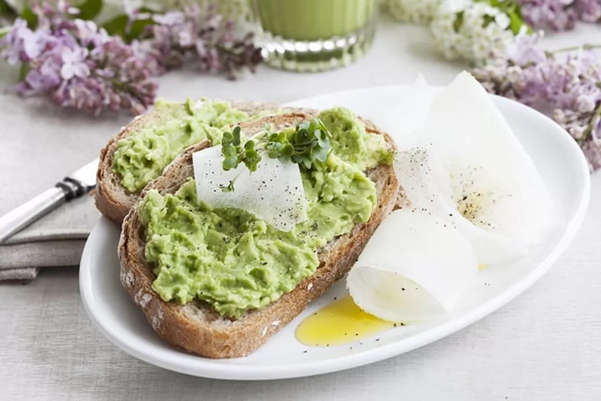 A slice of bread spread with generous lashings of avocado