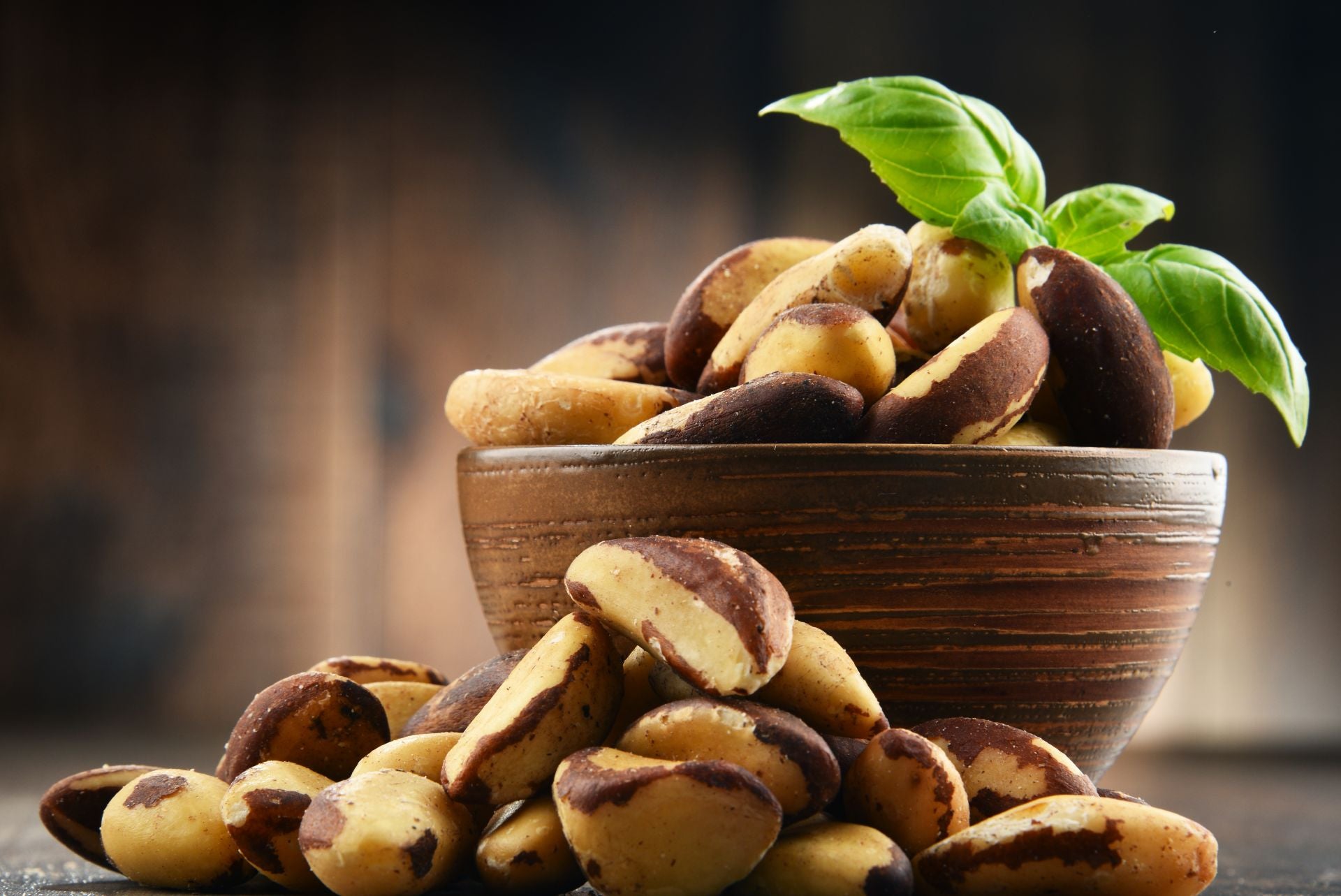 An overflowing wooden bowl of shelled Brazil nuts