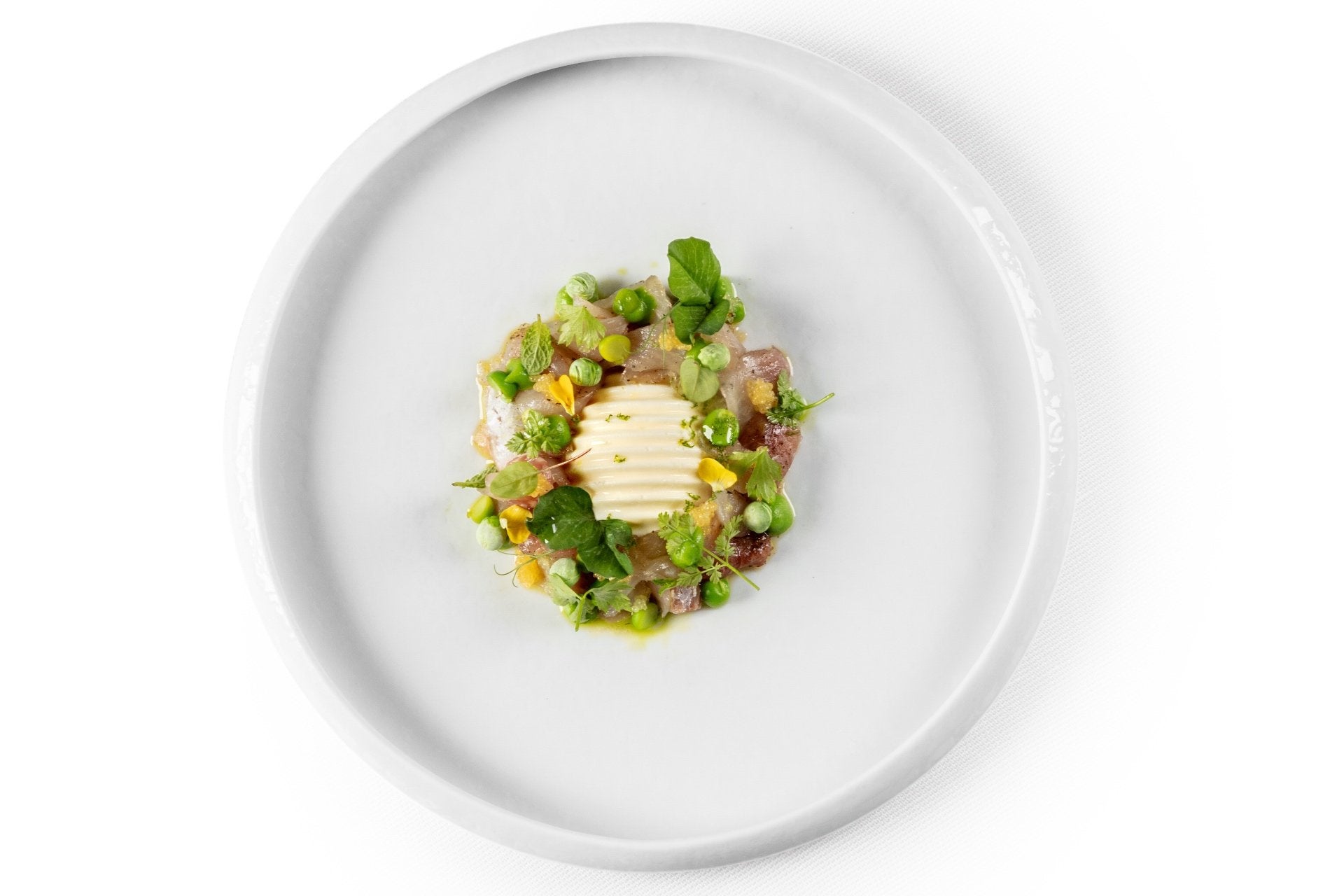 A fine dining dish with marscarpone and peas