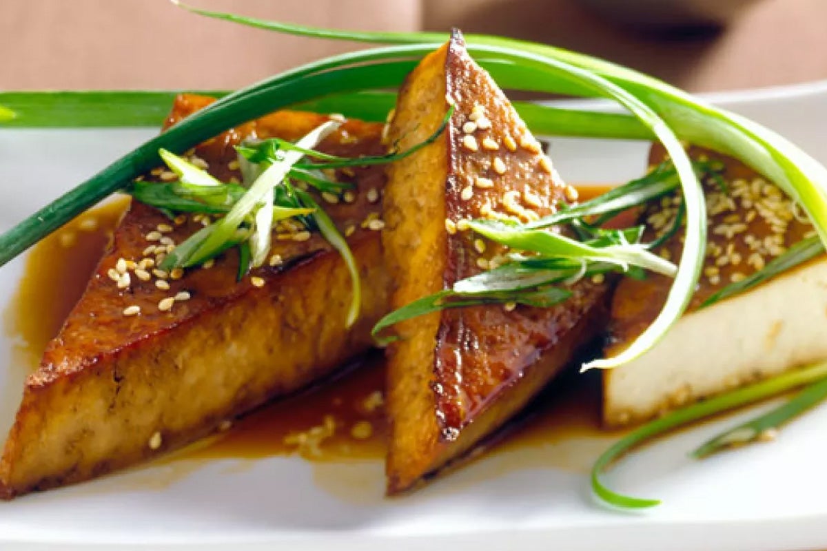 Fried tofu with sesame seeds and spring onions.