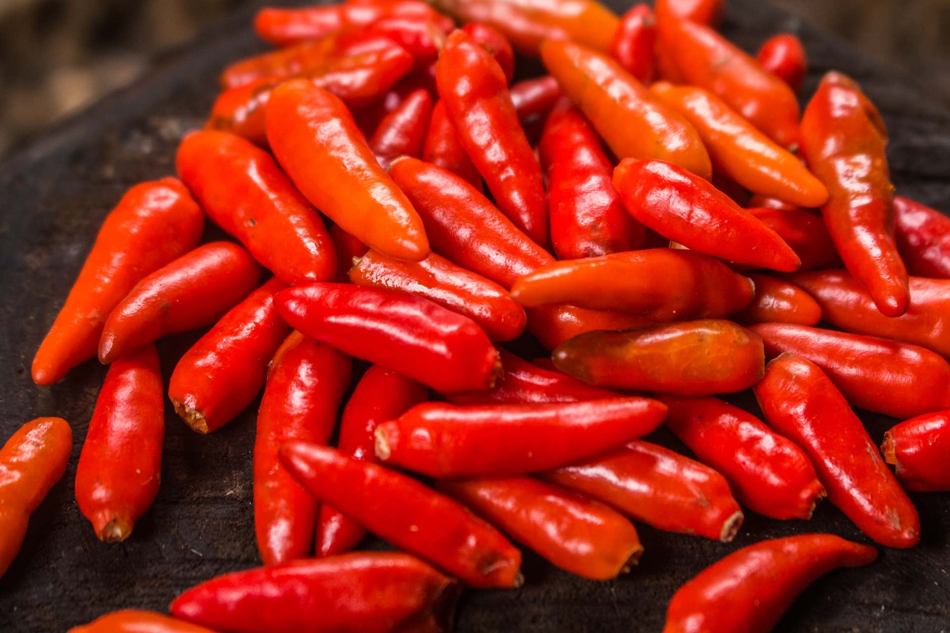 a heap of colourful red fresh jalapeno peppers