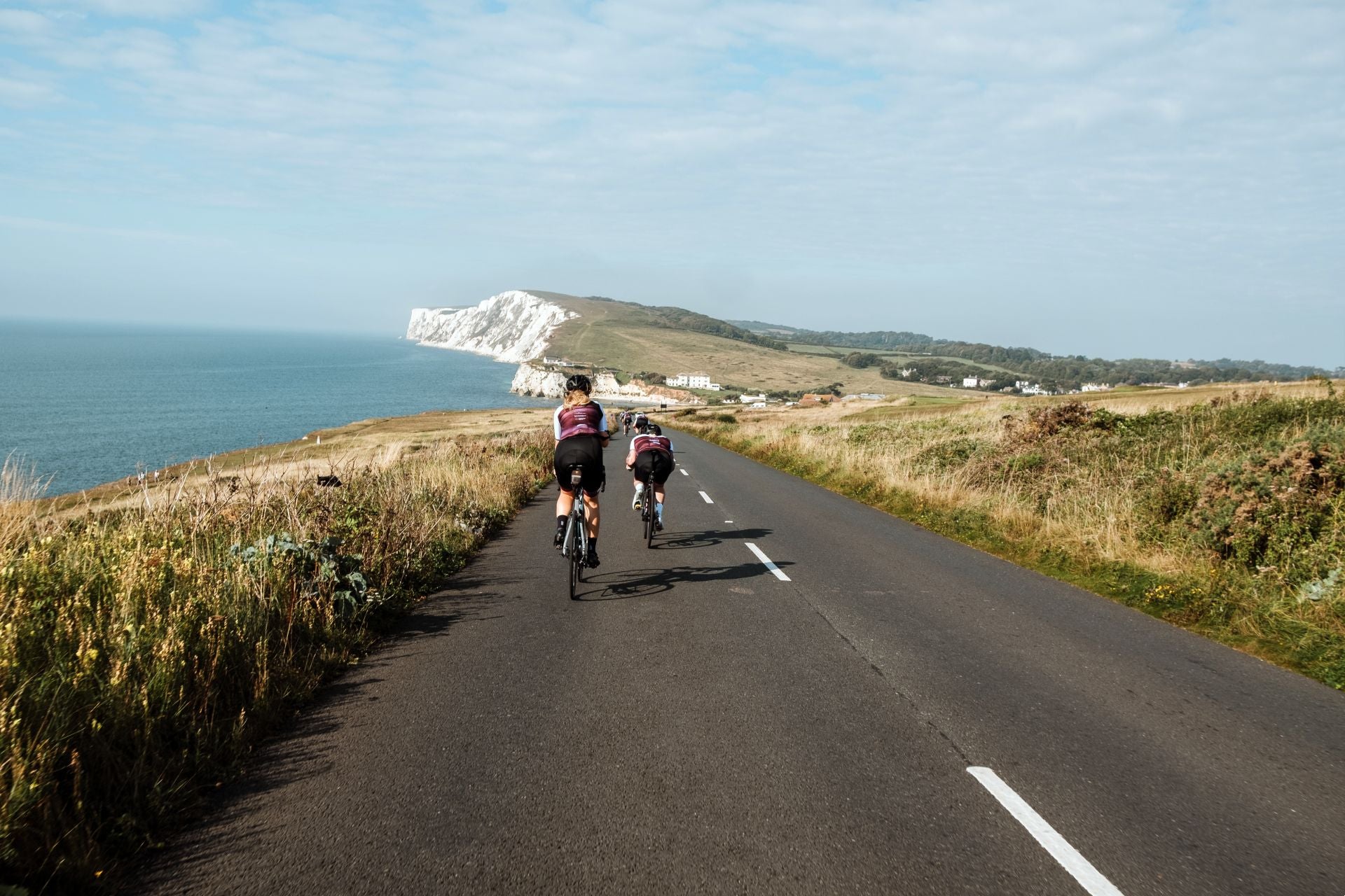 Cyclists on a coastal road.