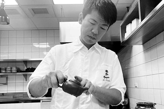 A black and white photo of a chef.