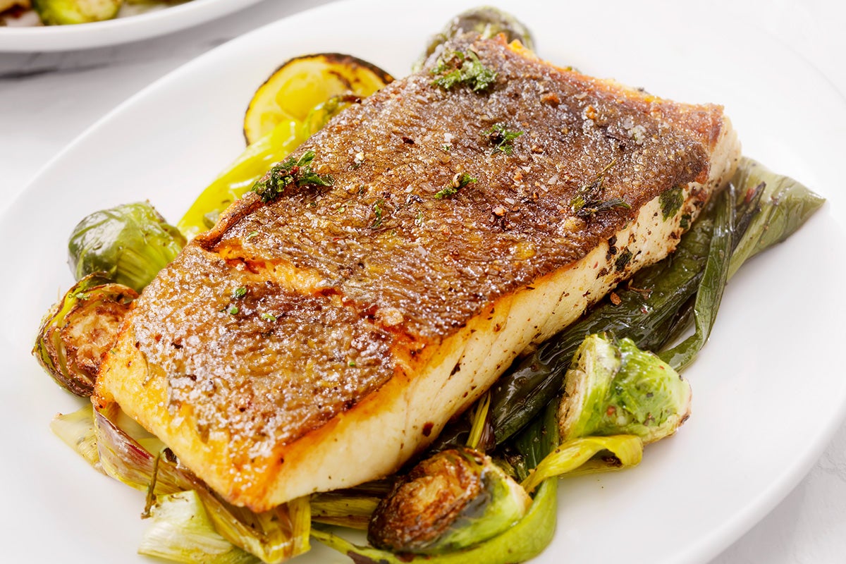 Fish with crispy skin on a plate.