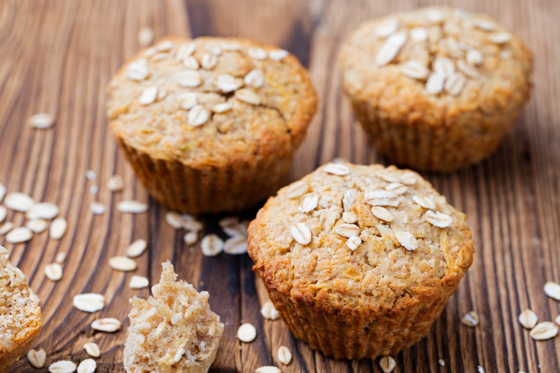 Freshly baked oatmeal muffins on a wooden board