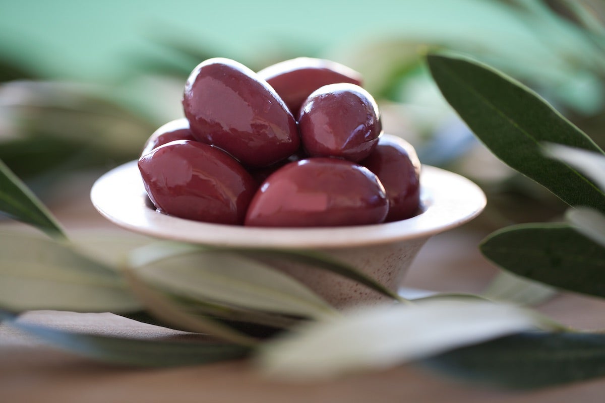 Bowl of oval, deep purple Alfonso olives grown in Chile
