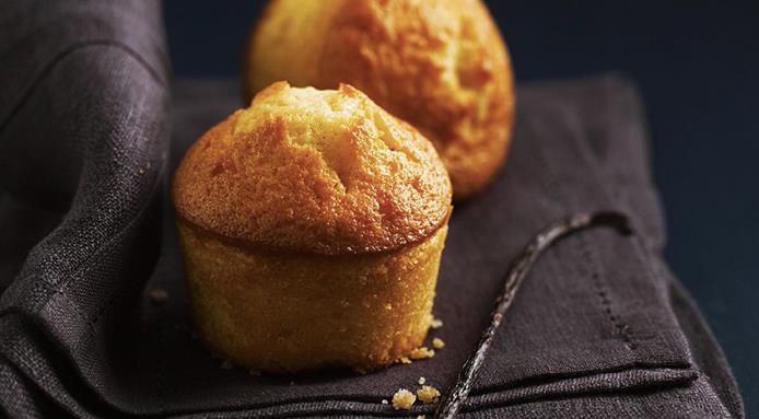 Two freshly baked muffins set on a napkin