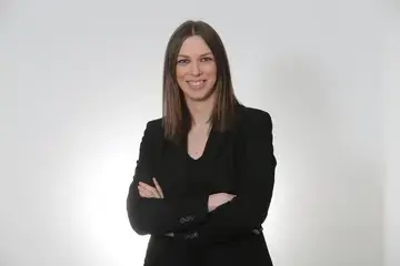 Journalist Federica Artina, wearing a black suit.