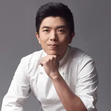 Chef Ton, resting his chin on his hand.
