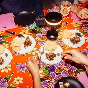 Dinner table with bright tablecloth at Haawm in Bangkok.