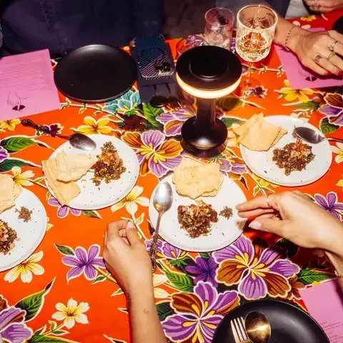 Dinner table with bright tablecloth at Haawm in Bangkok.