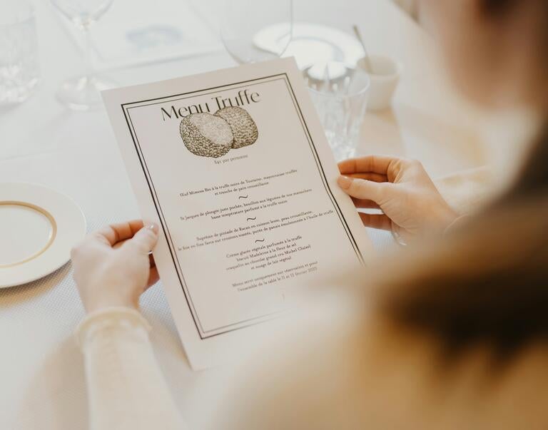 A woman holding a menu.