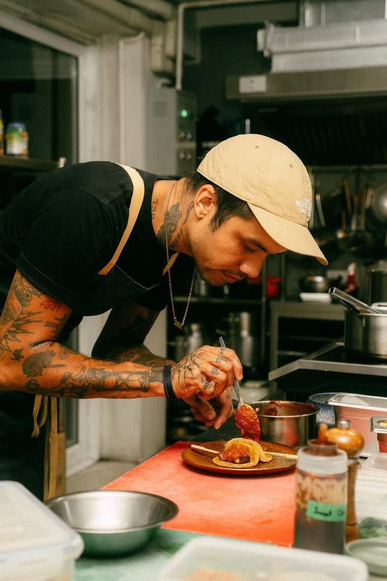 Chef Dylan Eitharong plating at Haawm.
