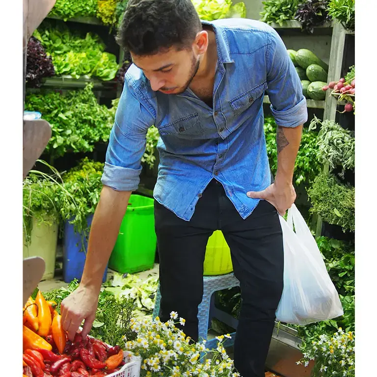 Nelson Freitas picking vegetables in Lima.