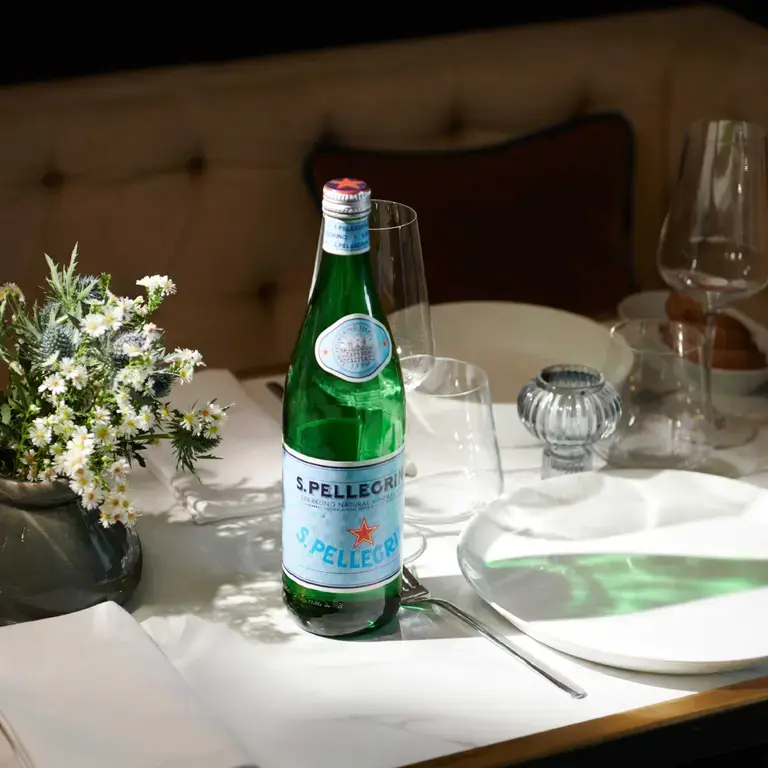 Bottle of S.Pellegrino on a dinner table.