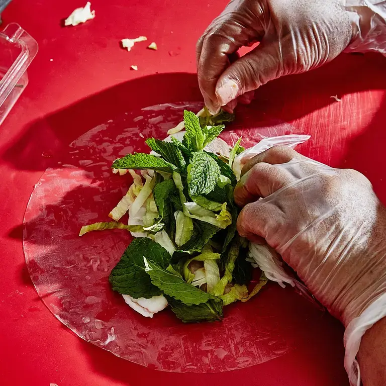 Person cooking on a red dish