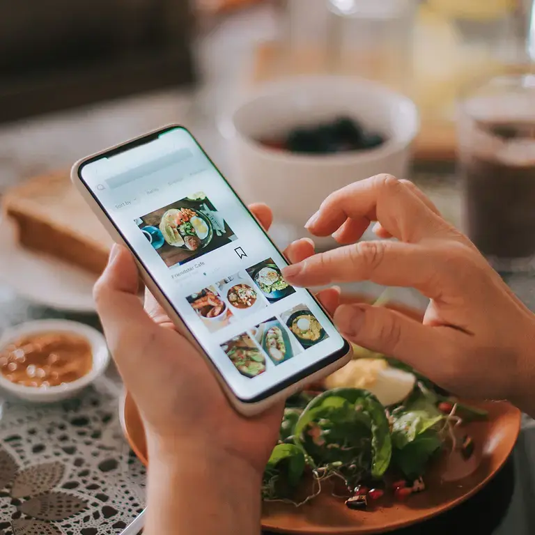 A person browsing food delivery on their phone.