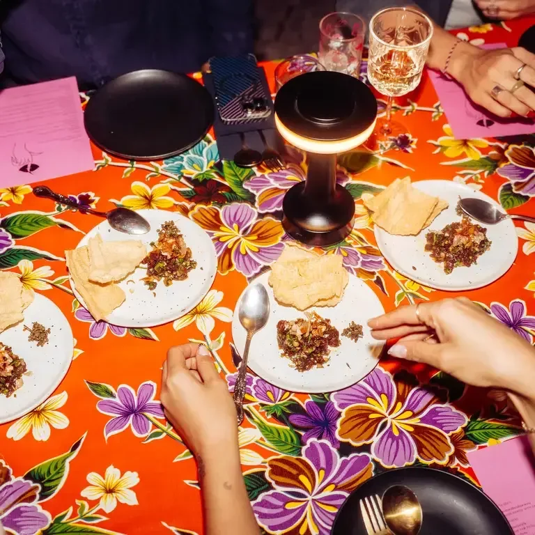 Dinner table with bright tablecloth at Haawm in Bangkok.