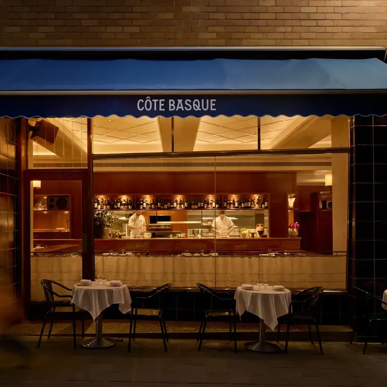 Interior of Côte Basque lit at night.