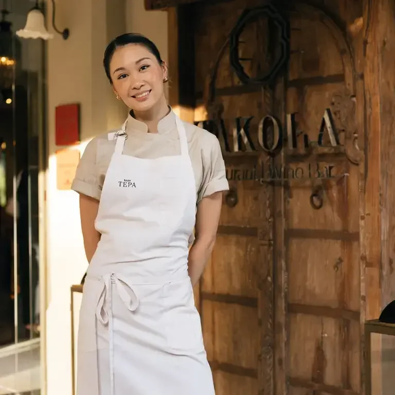 Chef Chudaree 'Tam' Debhakam in a white apron.