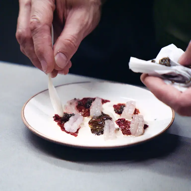 A seafood dish being plated at Firecat.