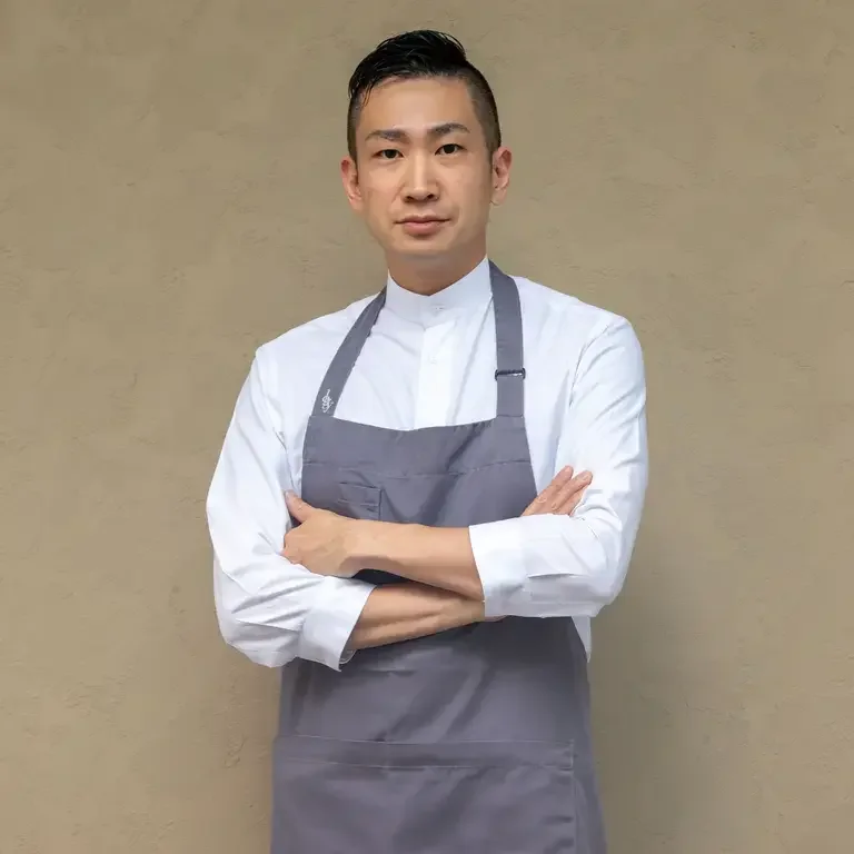 Chef Ryogo Tahara in a grey apron.