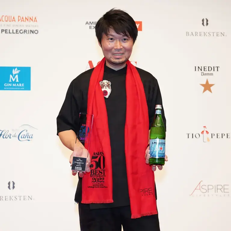 Zaiyu Hasegawa holding the trophy and a bottle of S.Pellegrino water