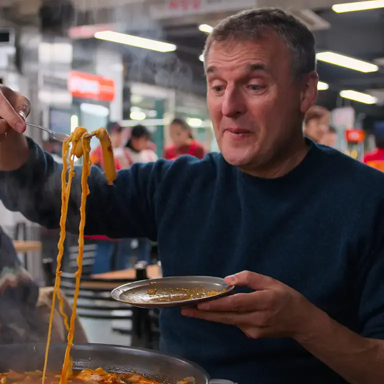 Phil Rosenthal eating noodles