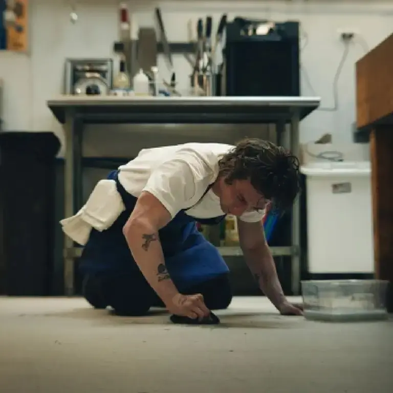 A chef cleaning the floor.