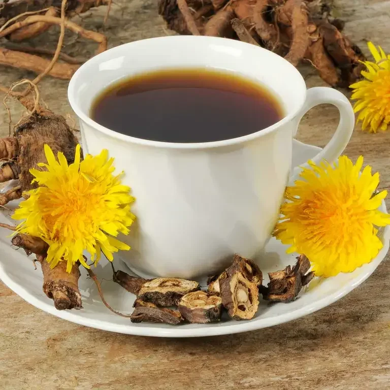 a teacup of dandelion coffee with fresh dandelions and roots