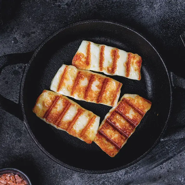 Baked halloumi in a skillet.