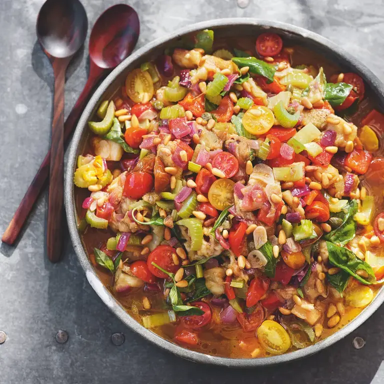 Tom Kerridge's BBQ caponata on a table with cutlery.
