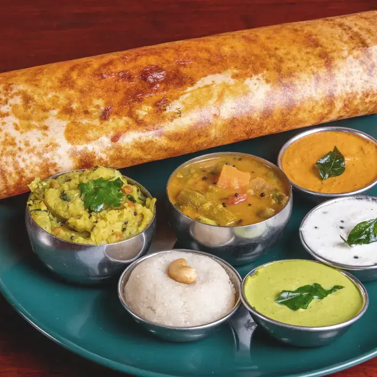 Dosa served with some typical Indian sauces.