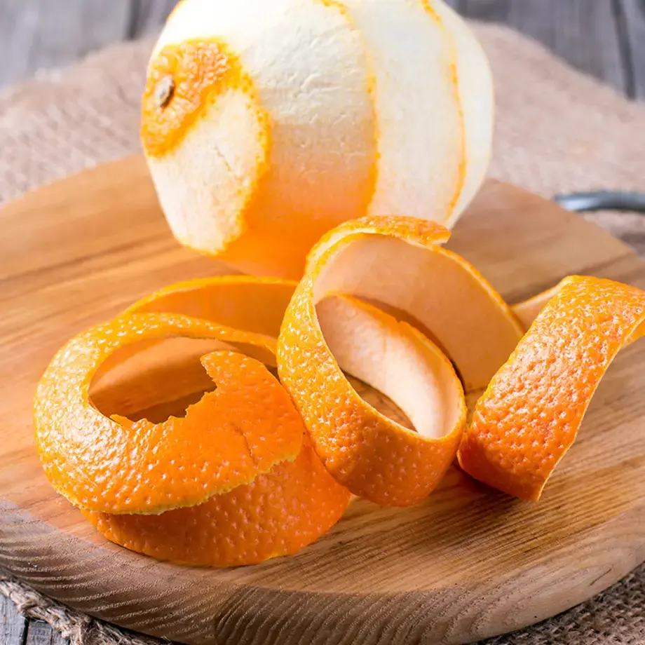 A peeled orange on a board.