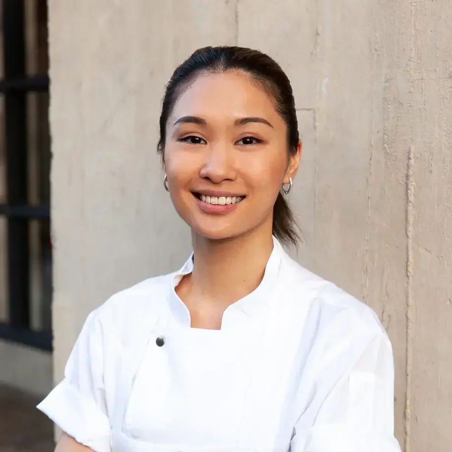 Chef Tam in chef's whites, smiling.
