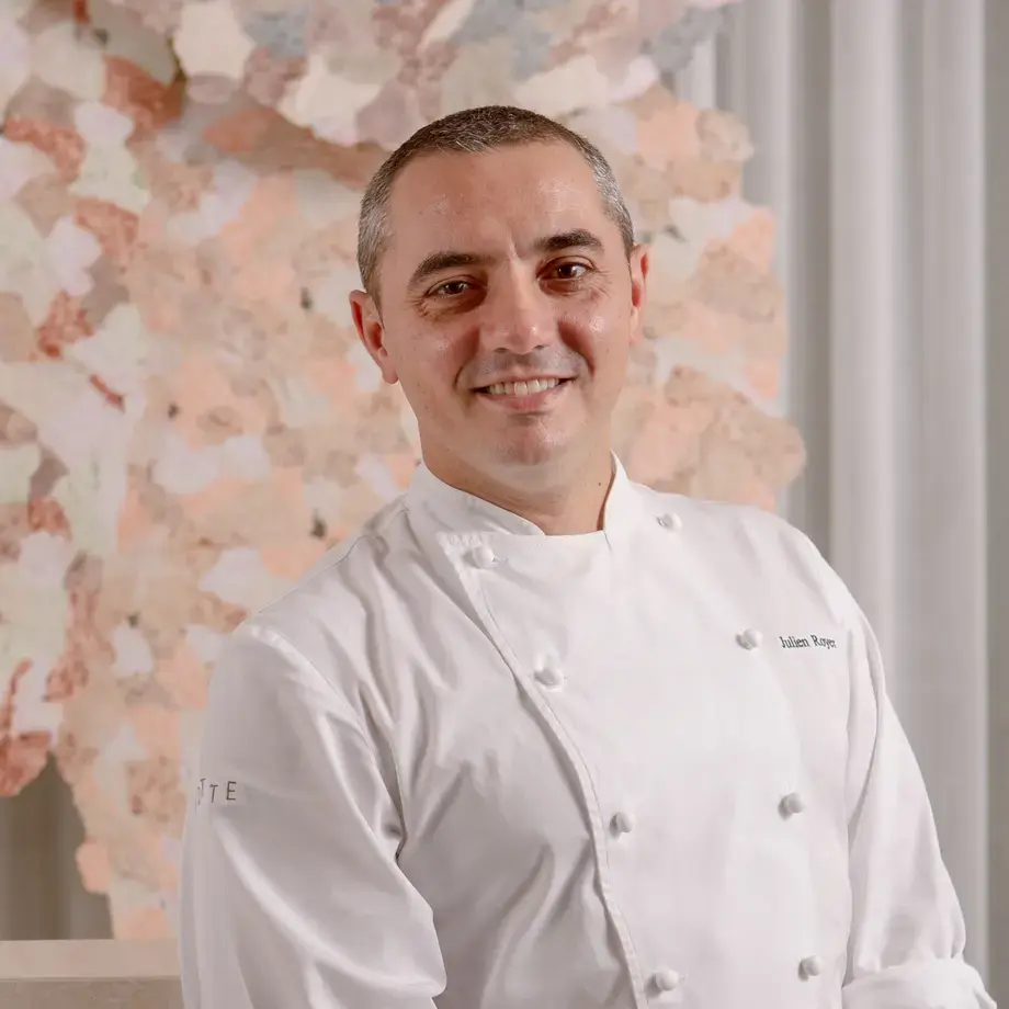 Chef Julien Royer in a chef's jacket, smiling.