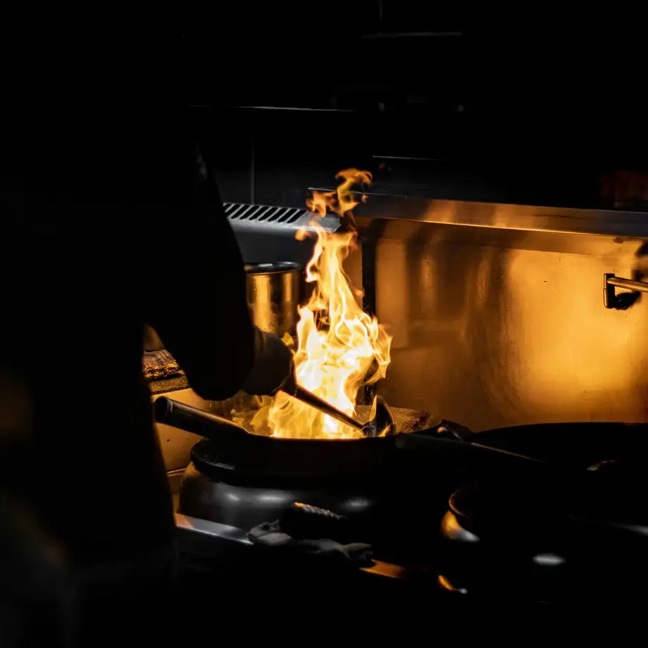 Cooking with flame using a wok