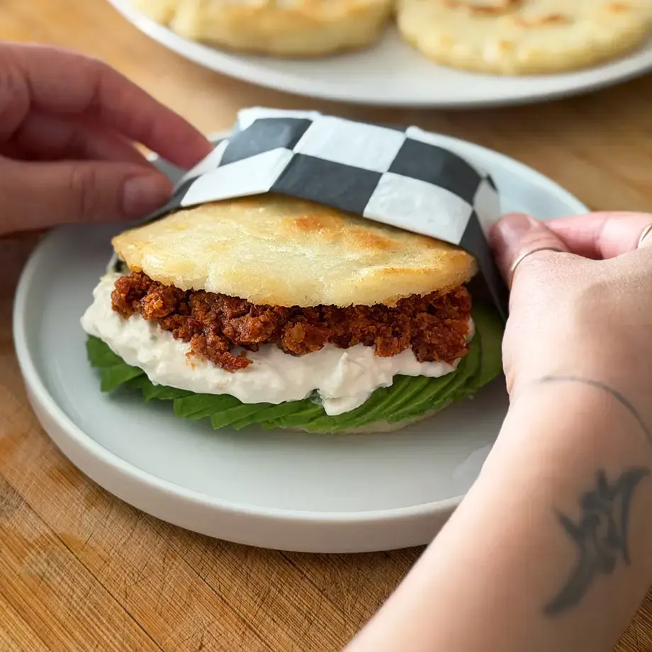 Venezuelan arepa with avocado, burrata and red pesto.