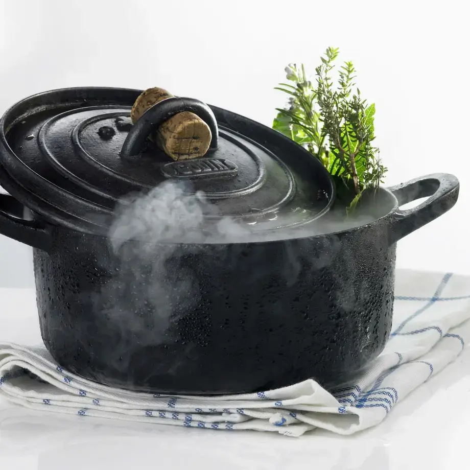 A steaming, black Dutch oven.