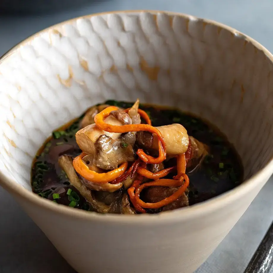 A bowl of food and spoon.
