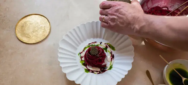 Michael Tusk plating spaghetti with caviar.