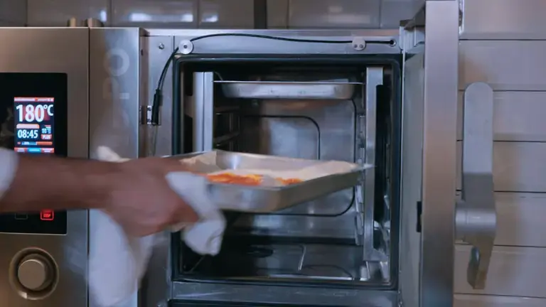 Preparation in the baking pan placed in the oven by the chef
