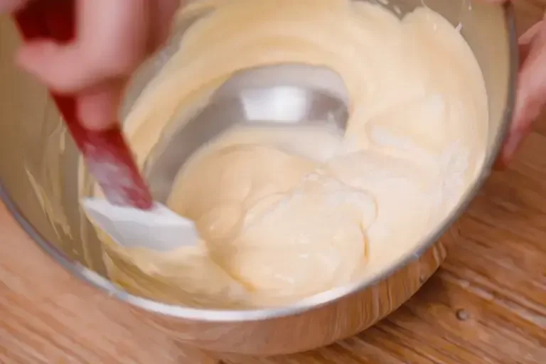 Folding the sifted flour in with a spatula.