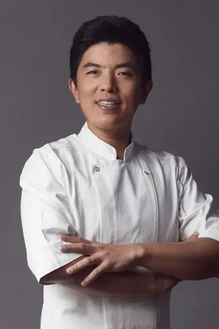 Chef Thitid 'Ton' Tassanakajohn with his arms folded.