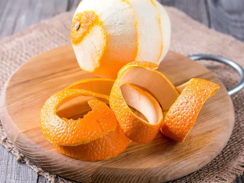 A peeled orange on a board.