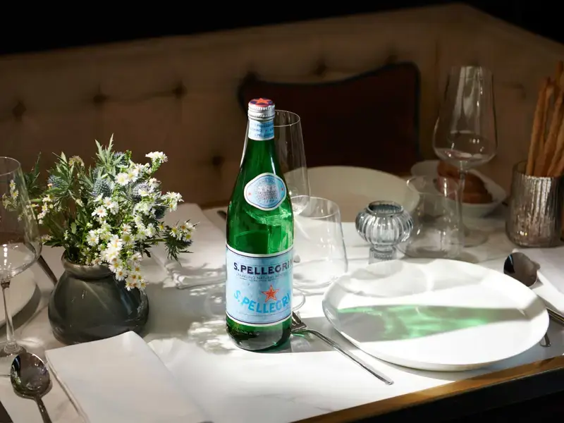 Bottle of S.Pellegrino on a dinner table.