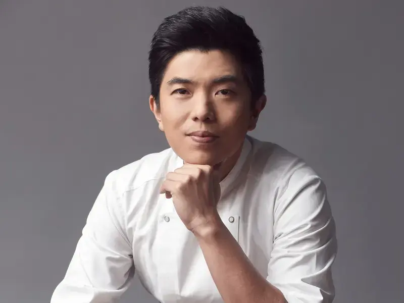 Chef Ton, resting his chin on his hand.