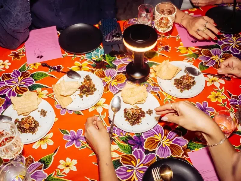 Dinner table with bright tablecloth at Haawm in Bangkok.