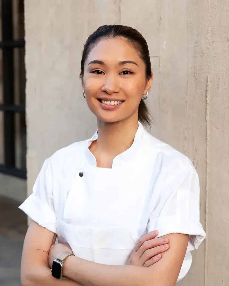 Chef Tam in chef's whites, smiling.